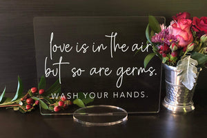 Elation Factory Co Weddings > Decorations > Signs Love is in the Air, but so are Germs - Wash Your Hands, Social Distancing Clear Acrylic Wedding or Business Event Sign, COVID 19 Safety